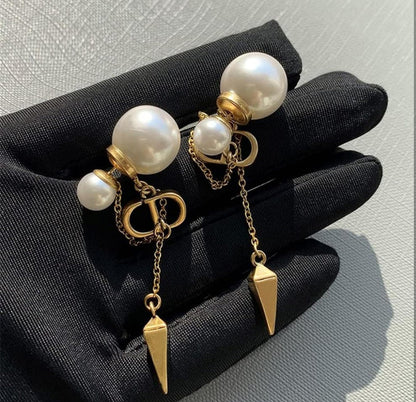 CD logo earrings with chain connect to pearl