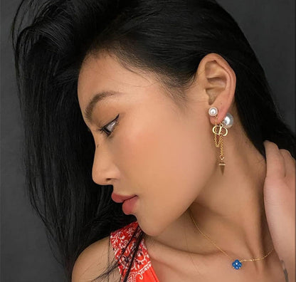 CD logo earrings with chain connect to pearl